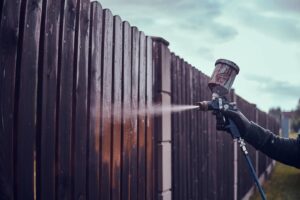 Man N Protective Gloves Is Applying Paint Old Fence Using Airbrush His Garden 613910 5620 1 | QPainting Services