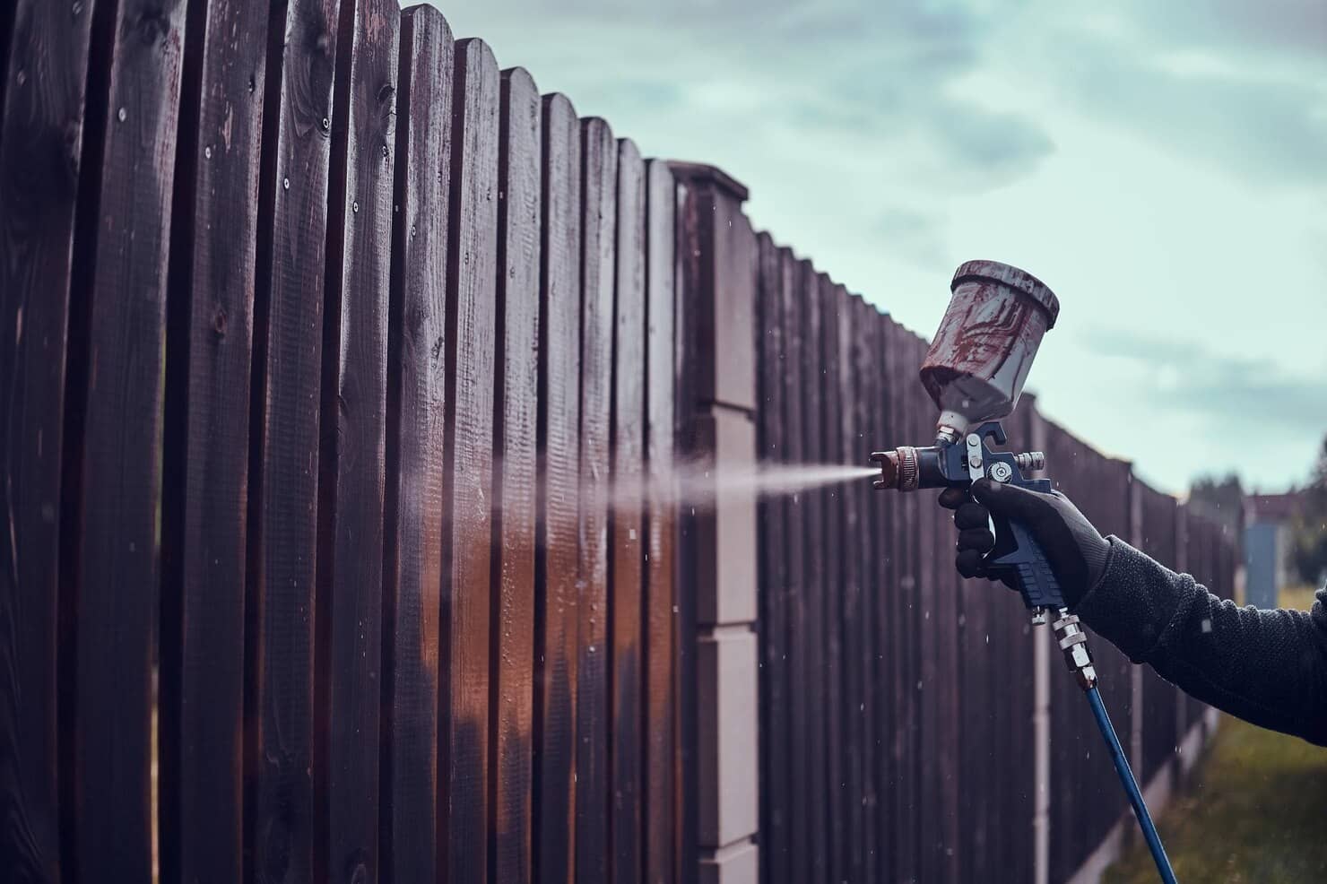 Man N Protective Gloves Is Applying Paint Old Fence Using Airbrush His Garden 613910 5620 1 | QPainting Services